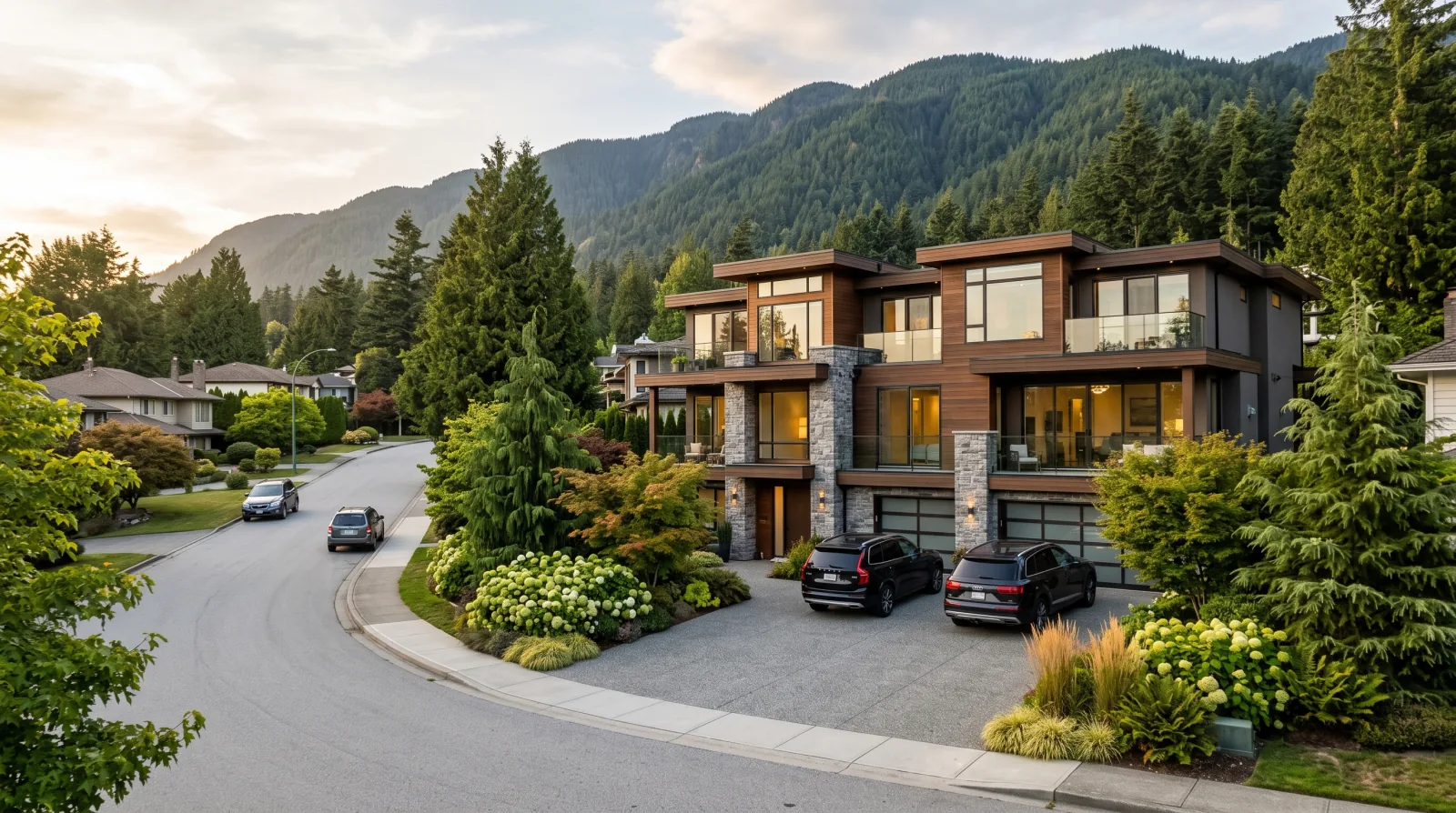 A modern multiplex on a curving street in the Tempe neighbourhood, northeast City of North Vancouver, with forested mountain slopes behind